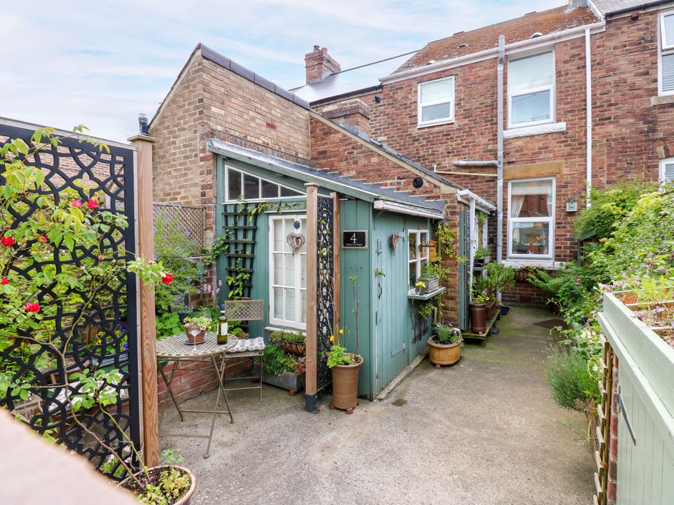 A garden area with a shed, table, and plants at 4 Ford Street Lanchester
