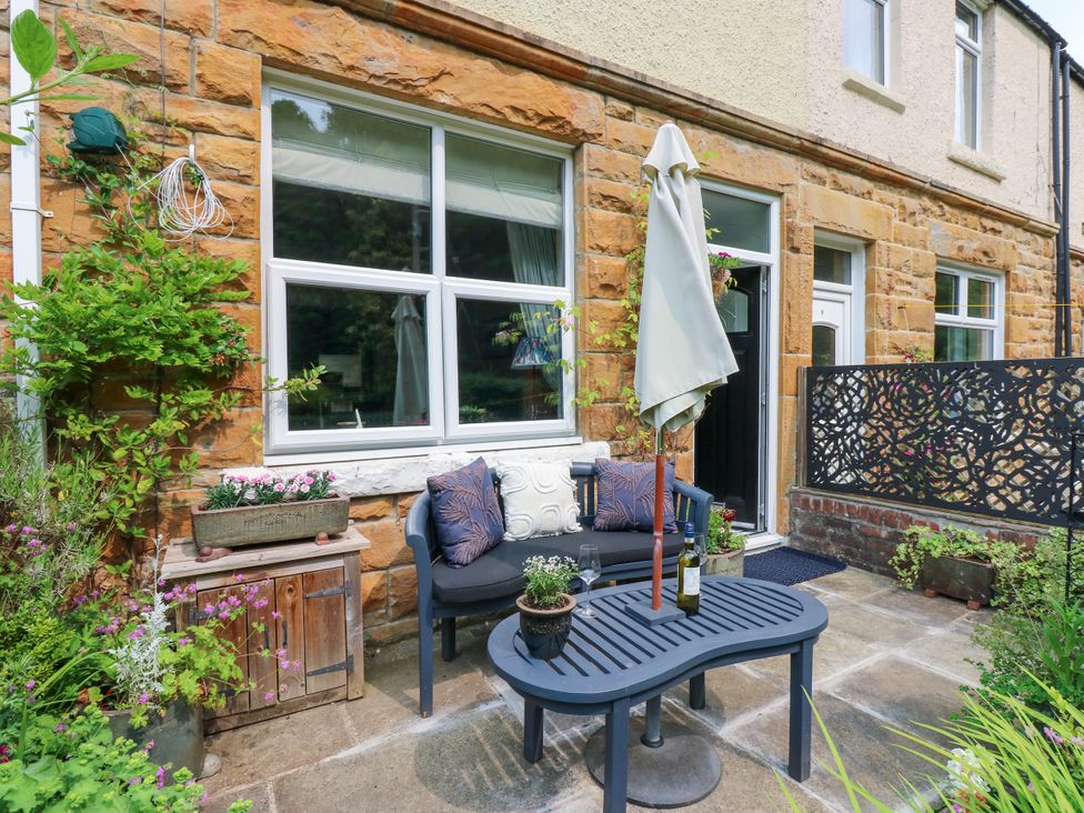 A seating area with a table and sofa at 4 Ford Street in Lanchester