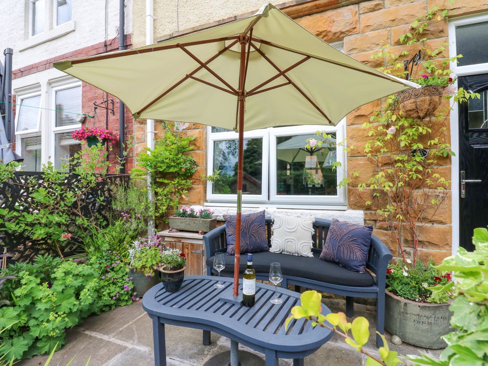 An outdoor seating area with a sofa, table, and plants at 4 Ford Street in Lanchester