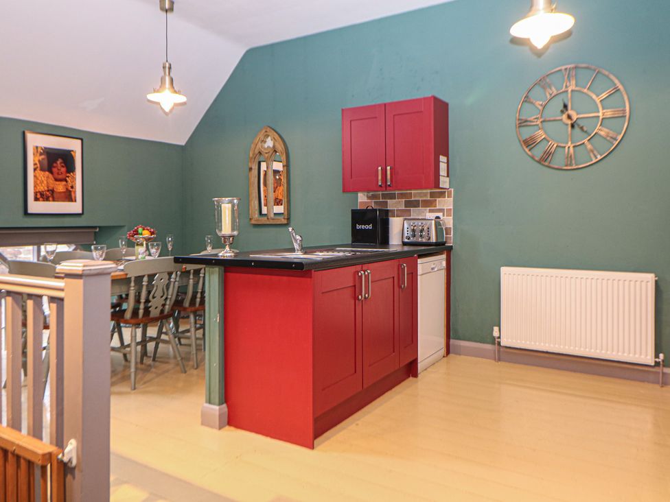 A kitchen with red cabinets and appliances at Nine Ladies in Birchover