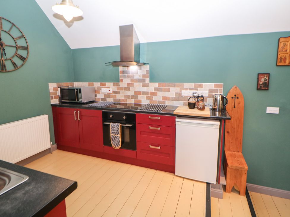 A kitchen with appliances and countertops at Nine Ladies in Birchover