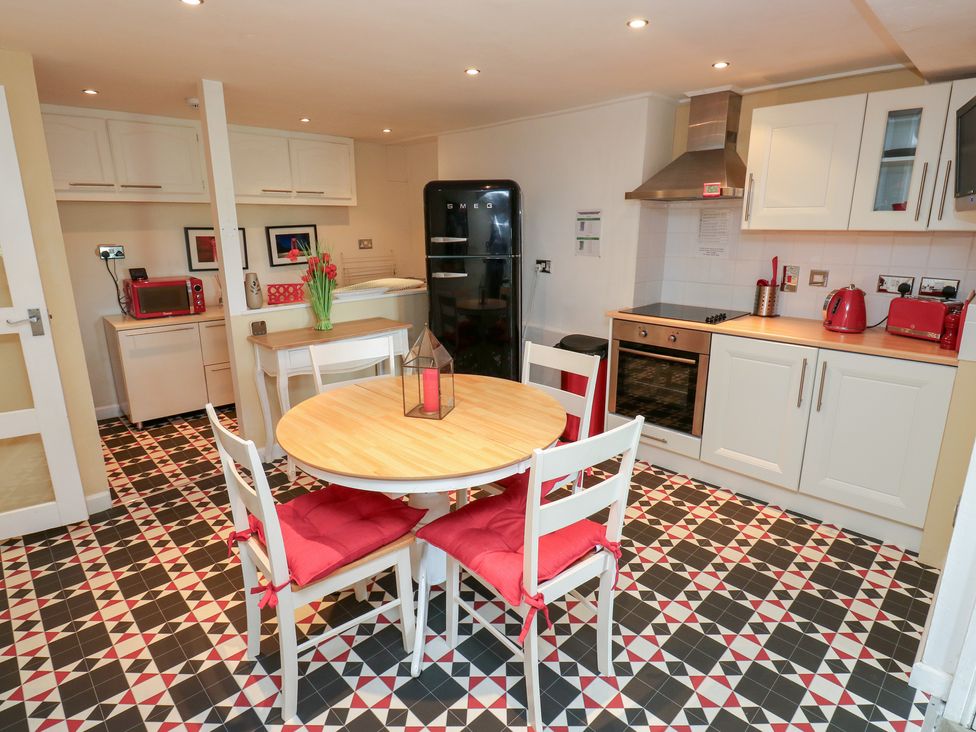 A kitchen with a table and chairs at The Thyme House in Haworth
