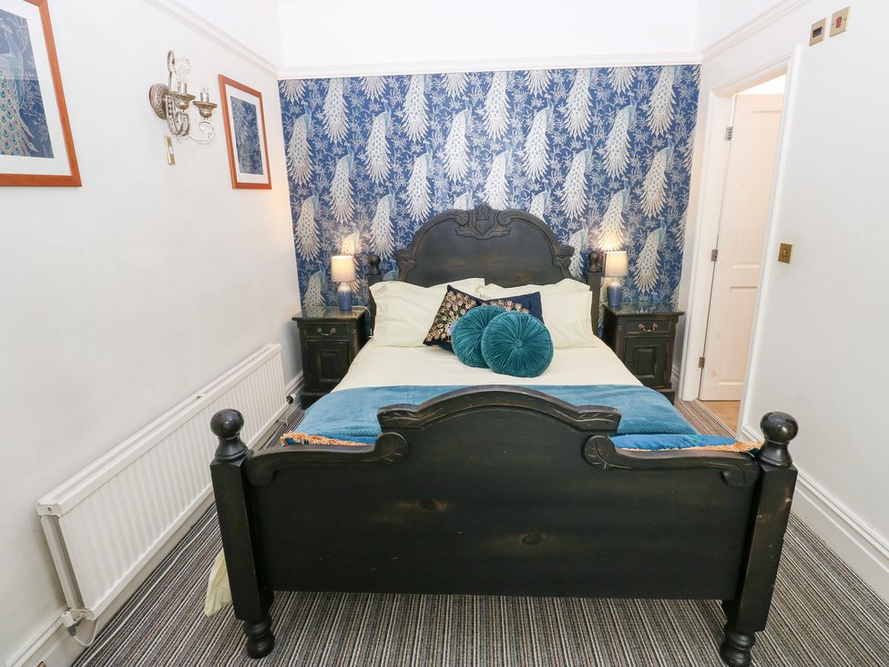 A bedroom with a bed and nightstands at The Thyme House in Haworth