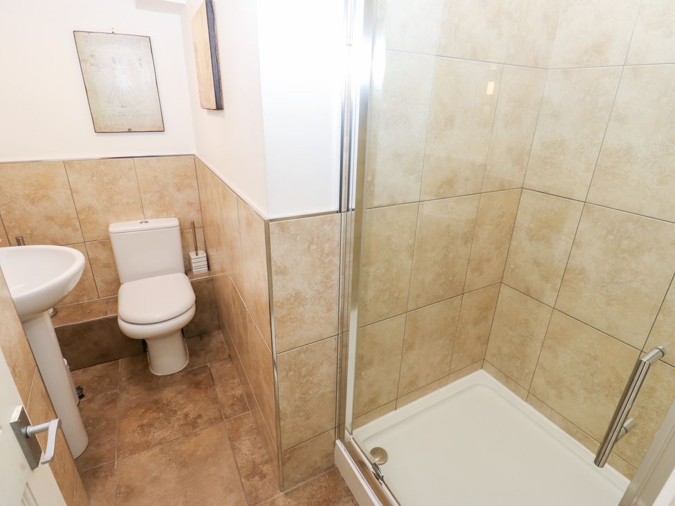 A bathroom with a shower, toilet and sink at The Thyme House, Haworth