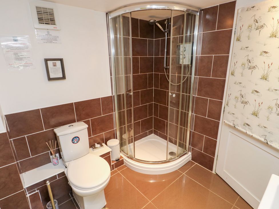 A bathroom with a shower and toilet at The Thyme House in Haworth
