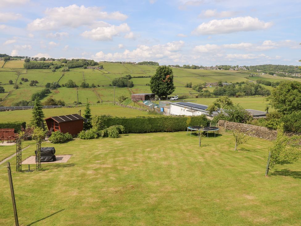 A garden with a trampoline and shed at The Thyme House in Haworth