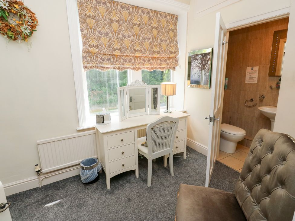 A bathroom with a vanity table and toilet at The Thyme House in Haworth