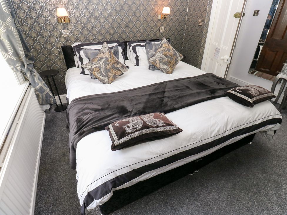 A bedroom with a bed and pillows at The Thyme House in Haworth