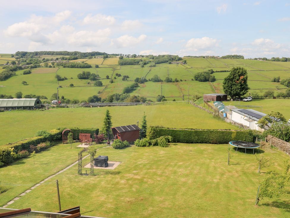 A garden with a trampoline and shed at The Thyme House in Haworth