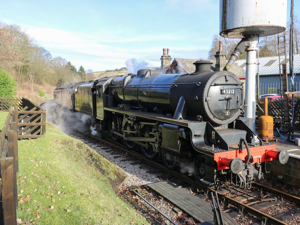 A steam engine with passenger car at The Thyme House in Haworth