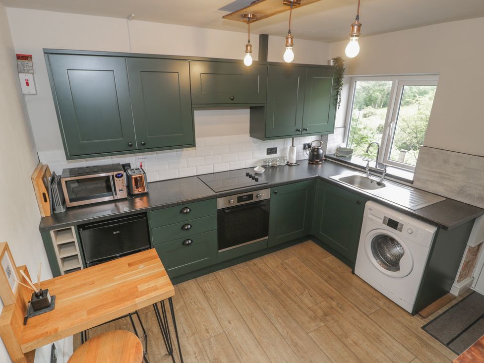 A kitchen with appliances and a counter at Pengeulan in Cemmaes