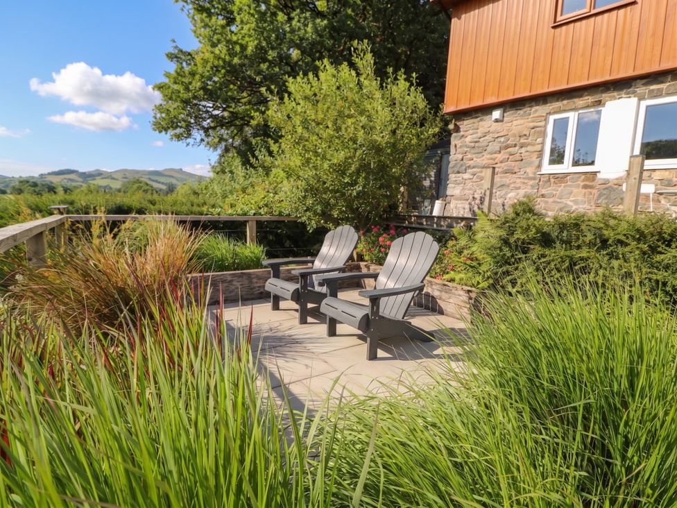 An outdoor seating area with chairs and plants at Pengeulan in Cemmaes