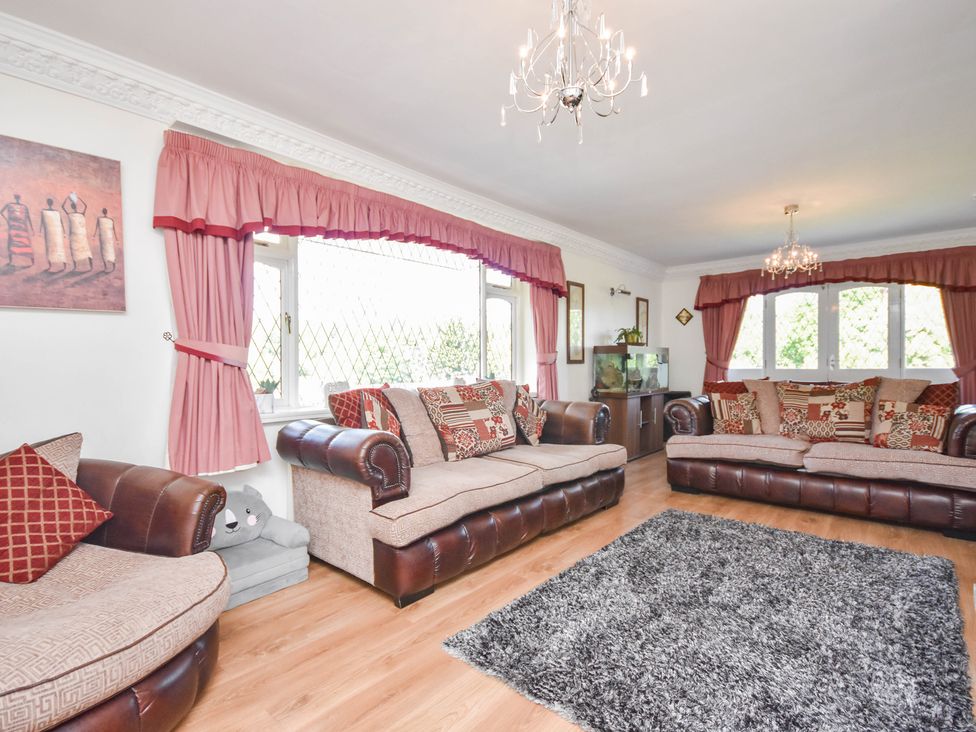 A living room with sofas and a fishtank at Freshwinds in Market Drayton
