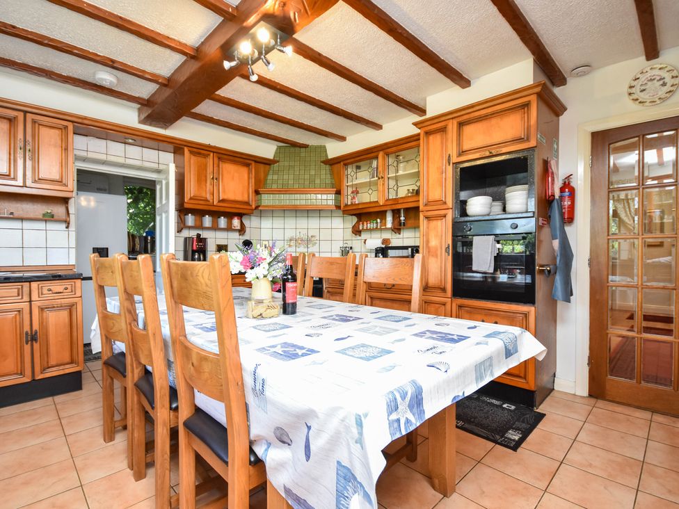 A kitchen with a dining table and chairs at Freshwinds in Market Drayton