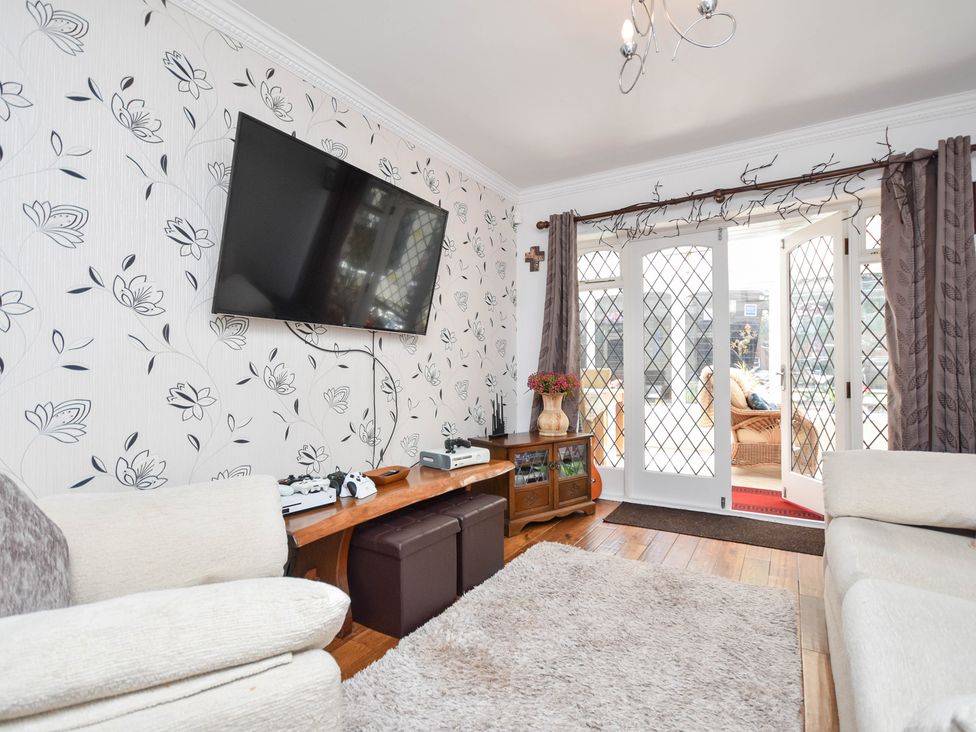 A living room with a television and sofa at Freshwinds in Market Drayton