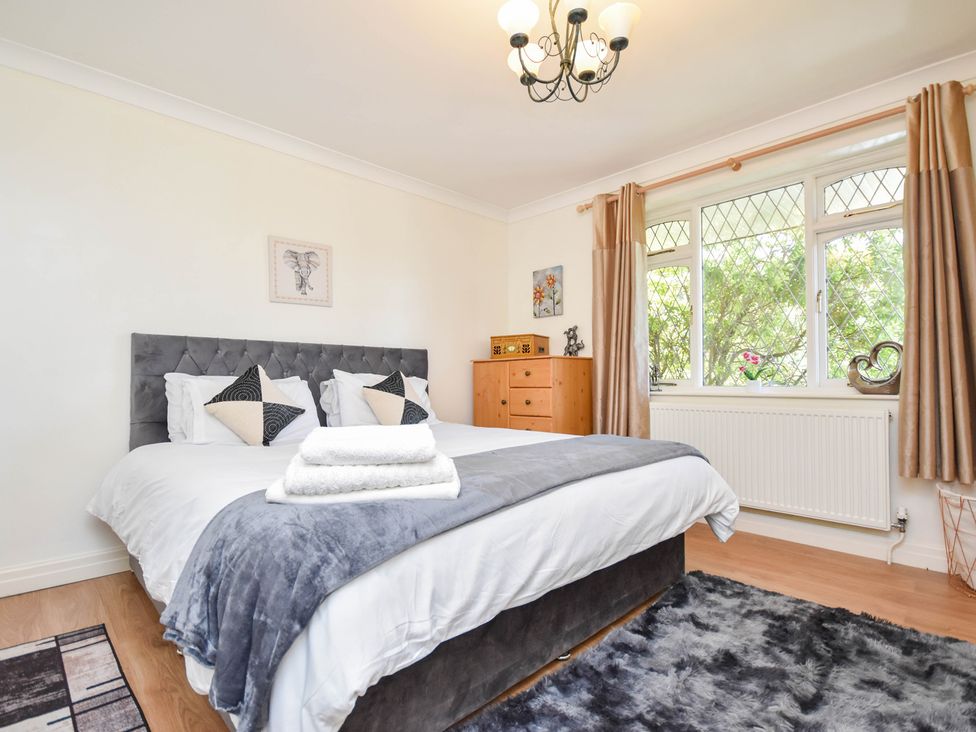 A bedroom with a bed and dresser at Freshwinds in Market Drayton