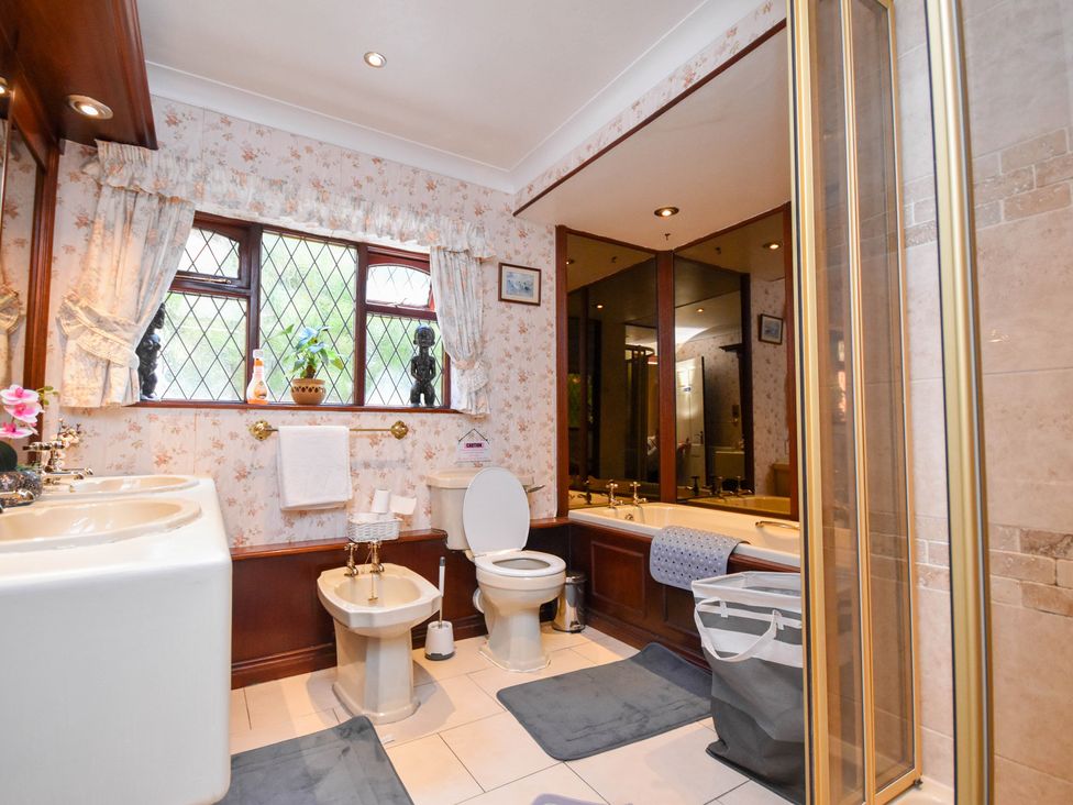 A bathroom with a bath tub and sink at Freshwinds in Market Drayton