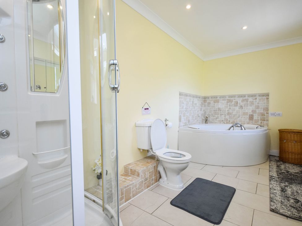 A bathroom with a shower, toilet, and bathtub at Freshwinds in Market Drayton