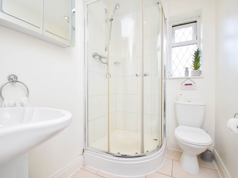 A bathroom with a shower, toilet and sink at Freshwinds in Market Drayton