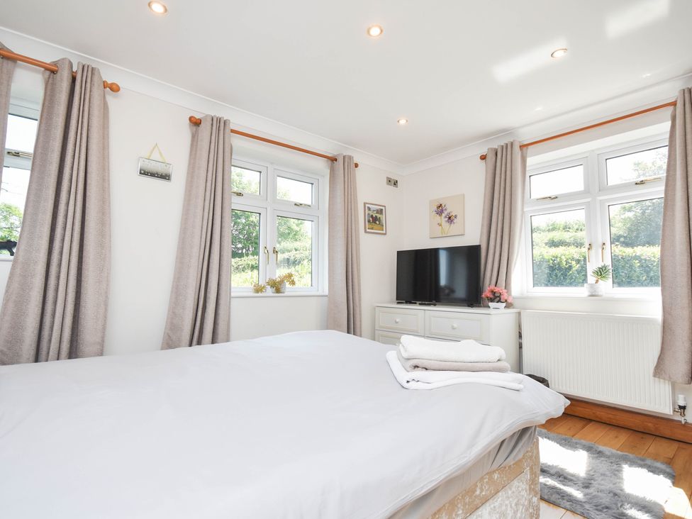 A bedroom with a bed and television at Freshwinds in Market Drayton