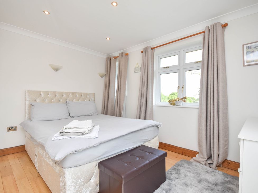A bedroom with a bed and window at Freshwinds in Market Drayton