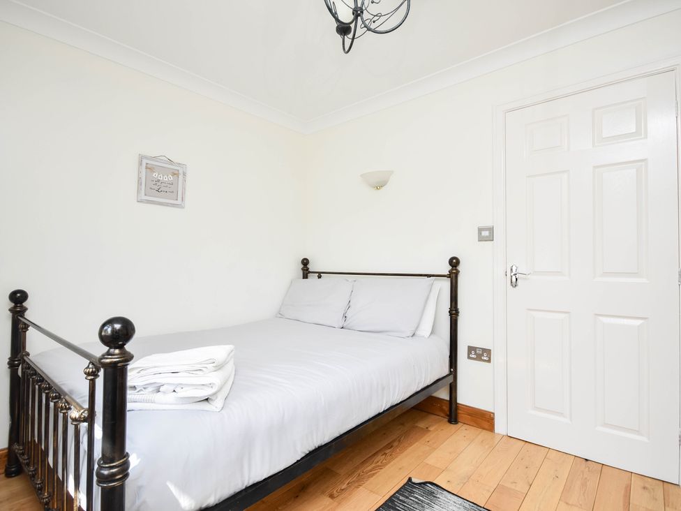 A bedroom with a bed and a door at Freshwinds in Market Drayton