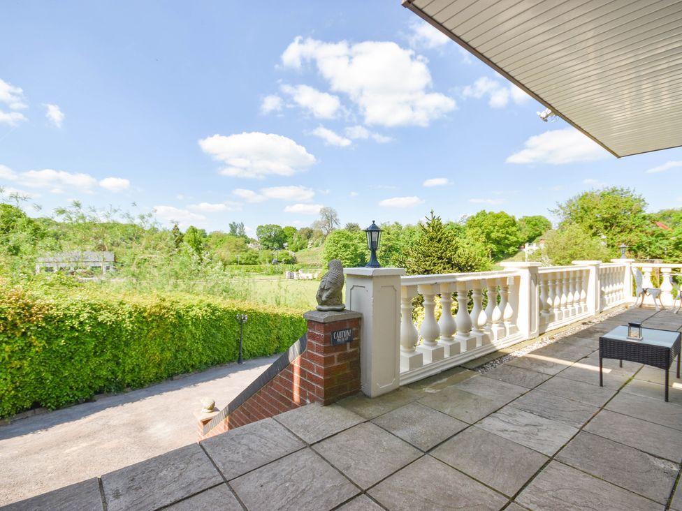 An outdoor area with a balcony and garden view at Freshwinds in Market Drayton