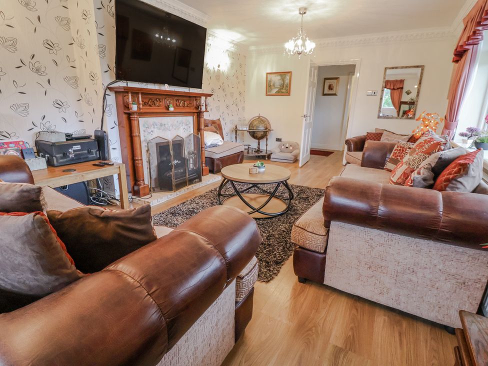 A living room with a fireplace and television at Freshwinds in Market Drayton