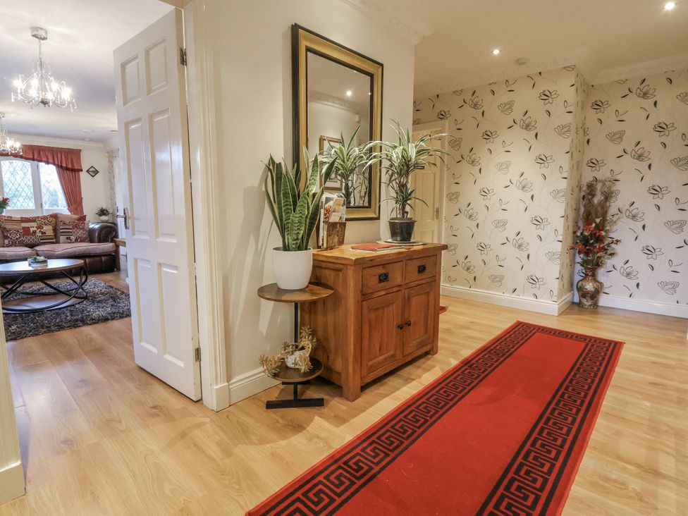 A hallway with a console table and plant at Freshwinds in Market Drayton