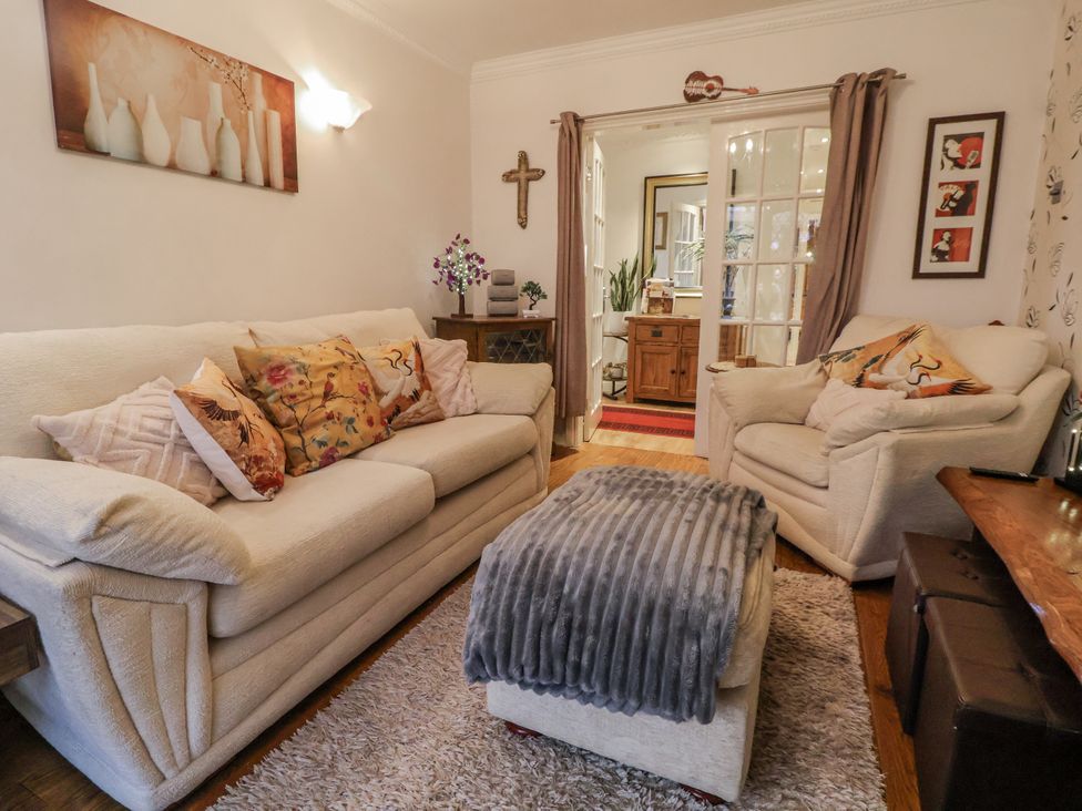 A living room with two sofas and a table at Freshwinds in Market Drayton