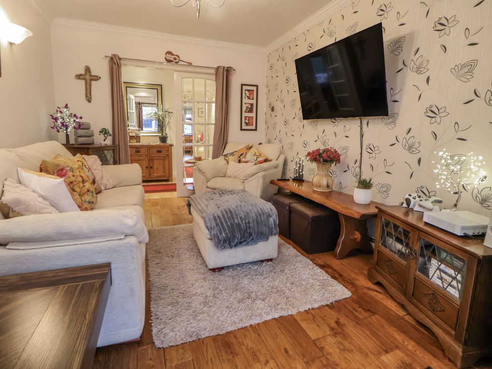 A living room with sofas and a television at Freshwinds in Market Drayton