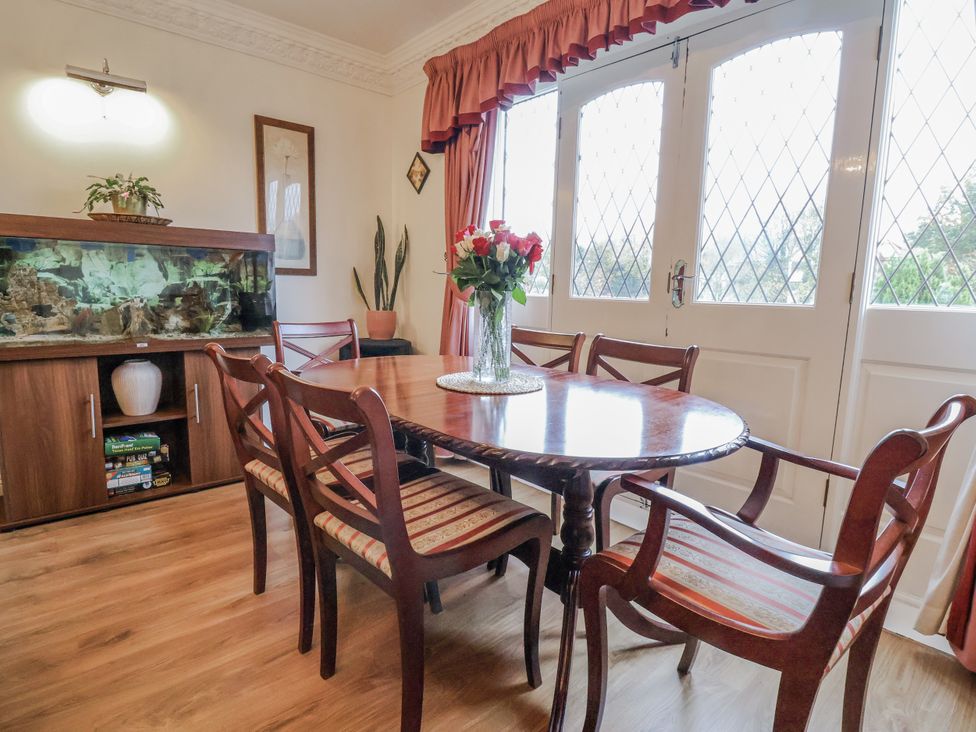 A dining room with a table and chairs at Freshwinds in Market Drayton
