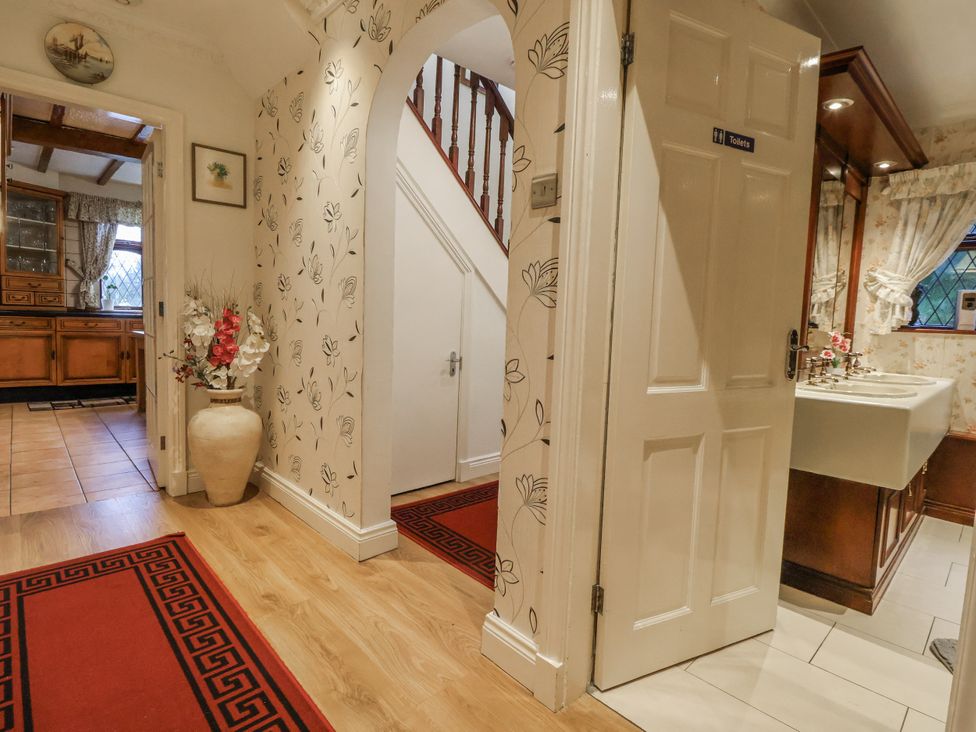 A hallway with stairs and a sink at Freshwinds in Market Drayton
