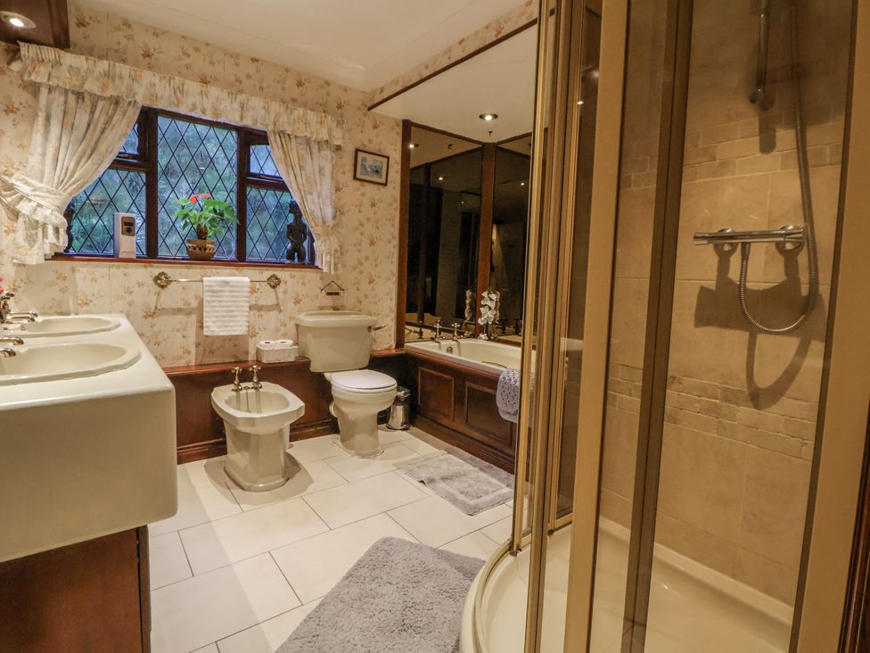 A bathroom with sinks, toilet, and shower at Freshwinds in Market Drayton