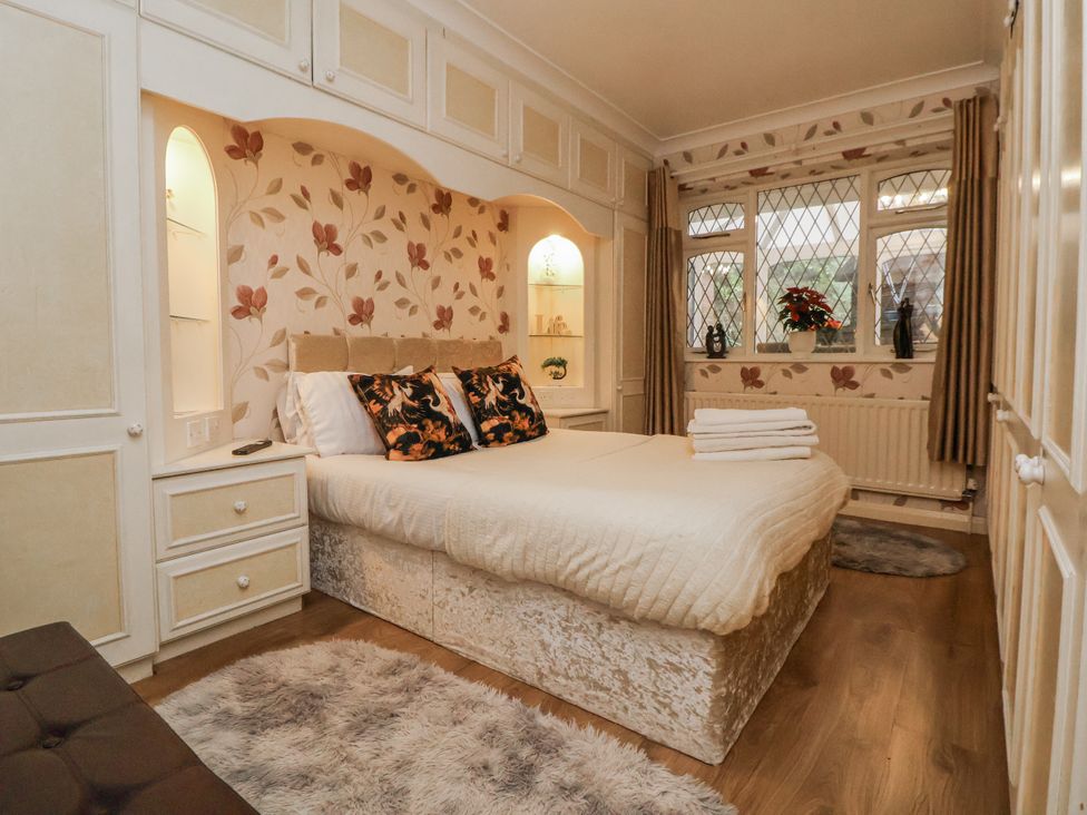 A bedroom with a bed and shelves at Freshwinds in Market Drayton