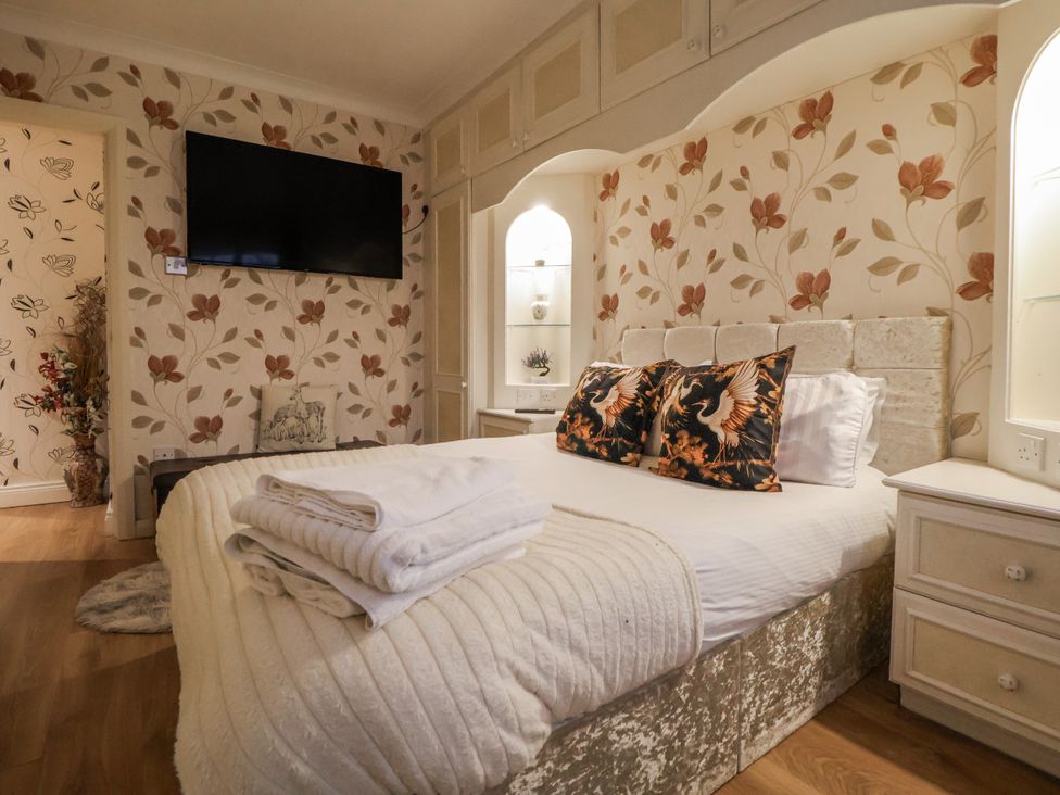 A bedroom with a bed and television at Freshwinds in Market Drayton