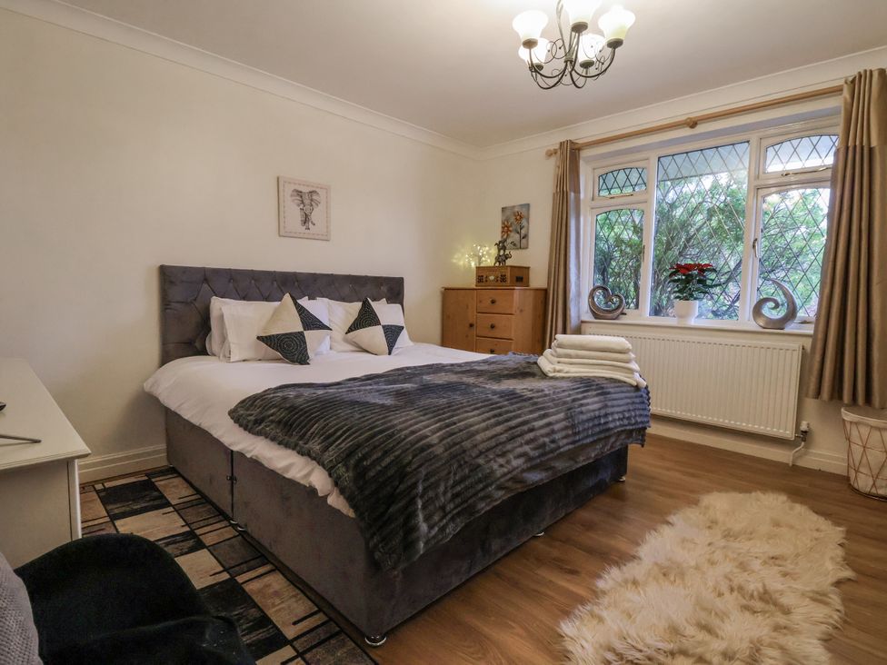 A bedroom with a bed and window at Freshwinds in Market Drayton