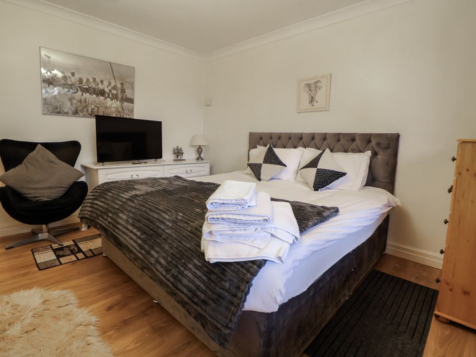 A bedroom with a bed and television at Freshwinds in Market Drayton