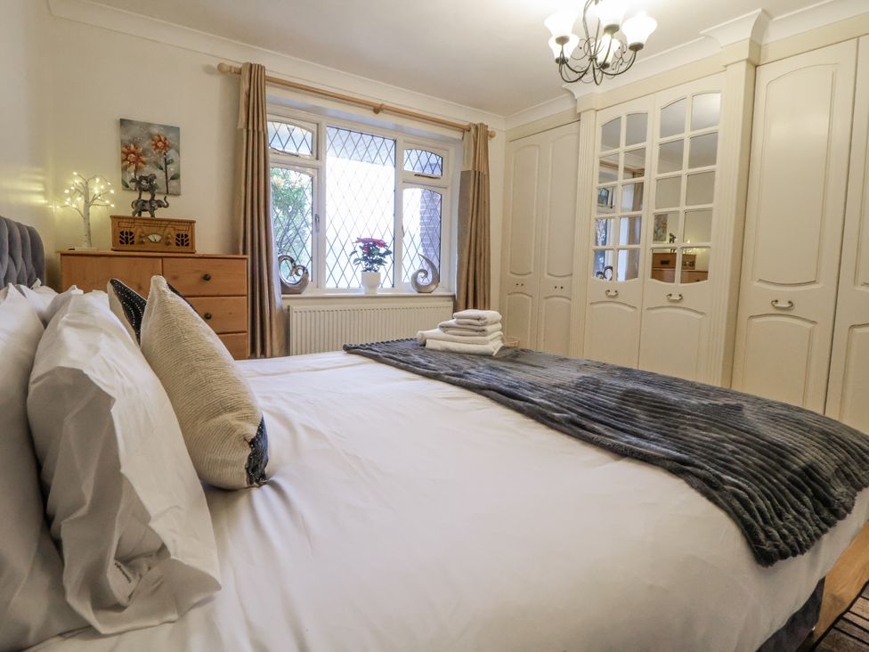 A bedroom with a bed and window at Freshwinds in Market Drayton