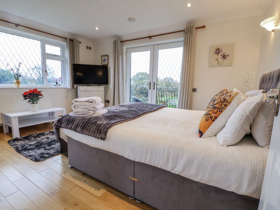 A bedroom with a bed and television at Freshwinds in Market Drayton