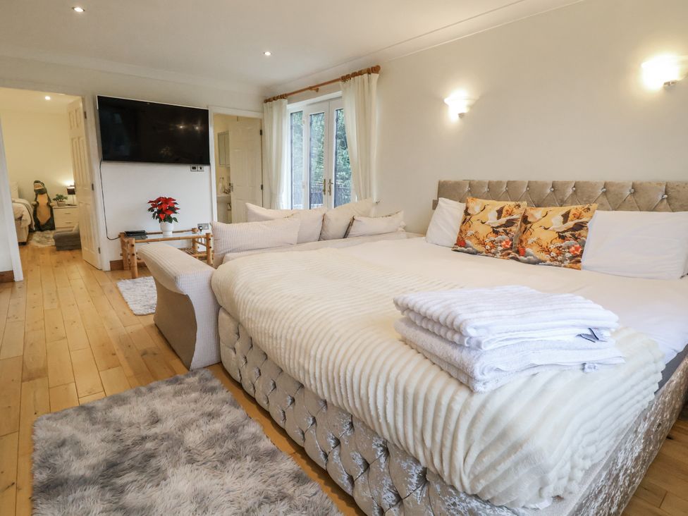 A bedroom with a bed and television at Freshwinds in Market Drayton