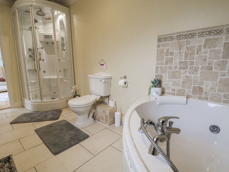 A bathroom with a shower and bathtub at Freshwinds in Market Drayton