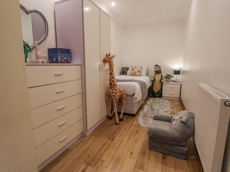 A bedroom with a bed and stuffed animals at Freshwinds in Market Drayton