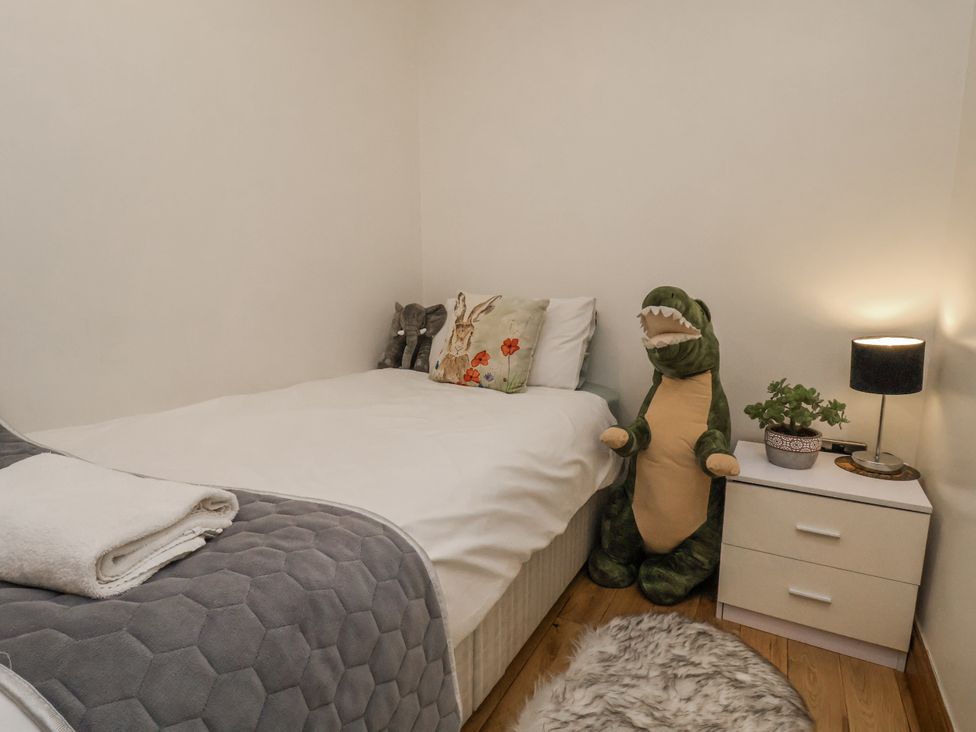 A bedroom with a bed and toys at Freshwinds in Market Drayton