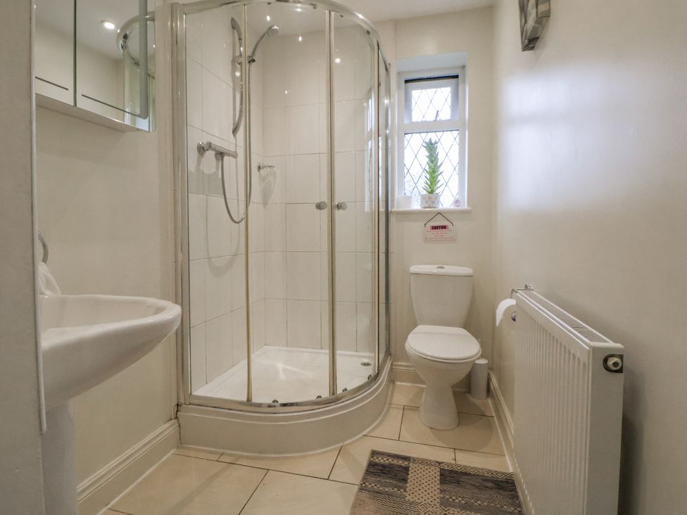 A bathroom with a shower, toilet, and sink at Freshwinds in Market Drayton