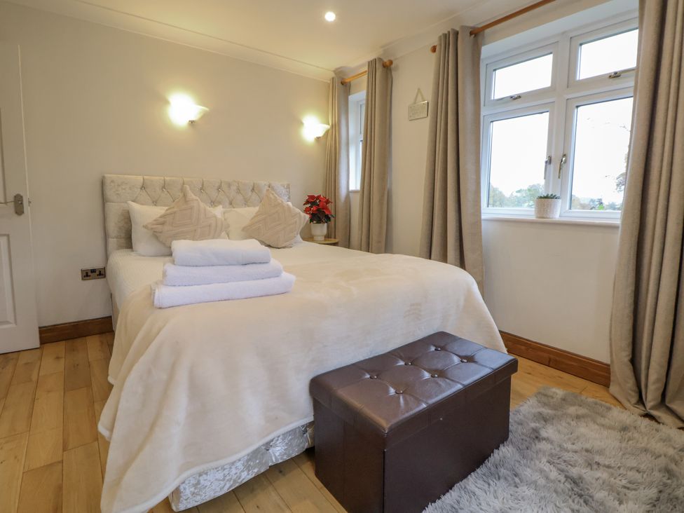 A bedroom with a bed and decorative items at Freshwinds in Market Drayton