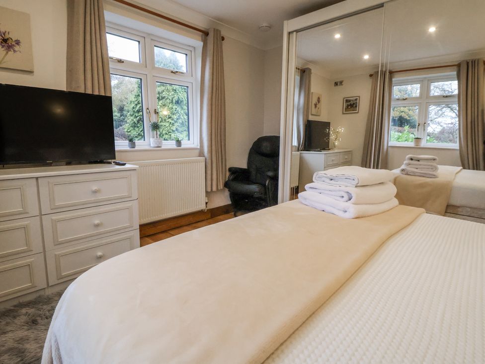 A bedroom with a bed and television at Freshwinds Market Drayton