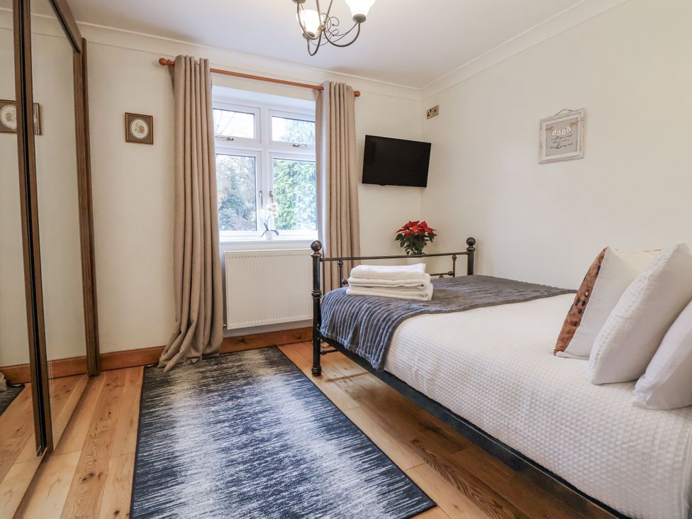 A bedroom with a bed and television at Freshwinds in Market Drayton