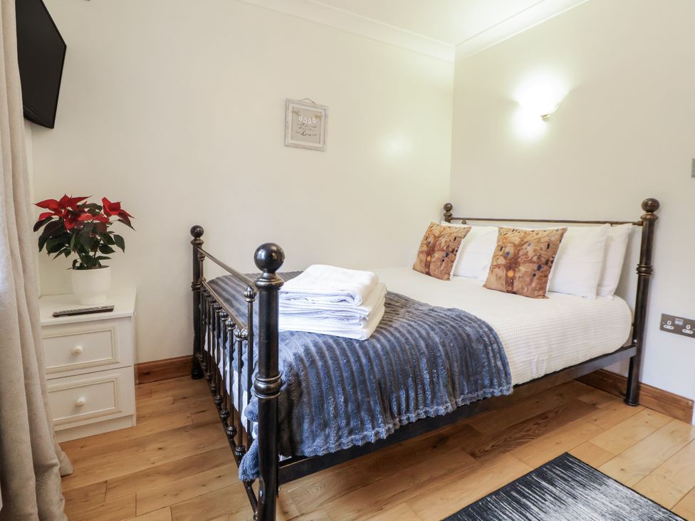 A bedroom with a bed and a plant at Freshwinds Market Drayton