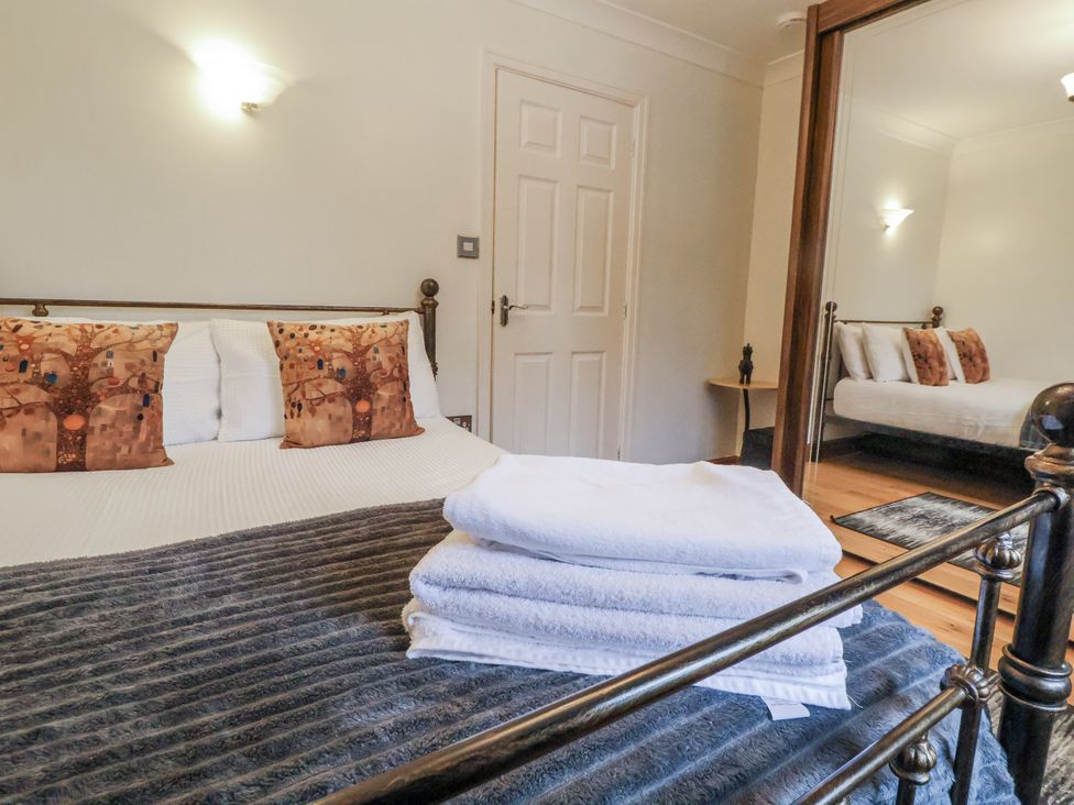 A bedroom with a bed and towels on the cover at Freshwinds in Market Drayton